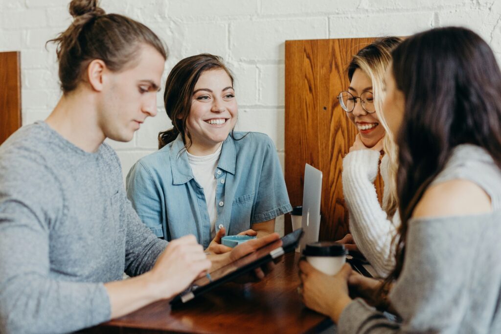 People huddled in a table while enjoying their coffees